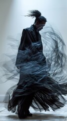 Elegant Woman in Black Dress with Flowing Fabric