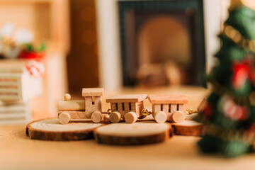 Cozy Christmas Scene with Wooden Miniature Train and Fireplace