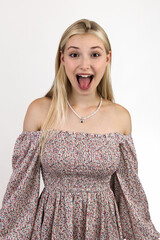 Photo portrait of a funny blonde grimacing and sticking out her tongue.