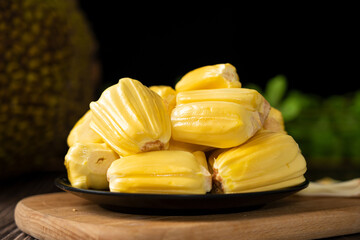 Ripe jackfruit peeled tropical fruit on table.