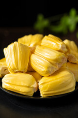 Ripe jackfruit peeled tropical fruit on table.