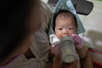 Asian baby girl drink milk from bottle,time for milk,go to the bed