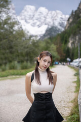 Woman walking in the pine forest dolomites, Italy.