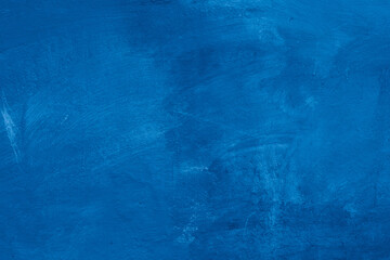 Grunge classic blue concrete background. Textured plaster wall. Creative backdrop for your design. Color of the year 2025 concept. Top view, layout for design. Surface with peeling shabby pattern.
