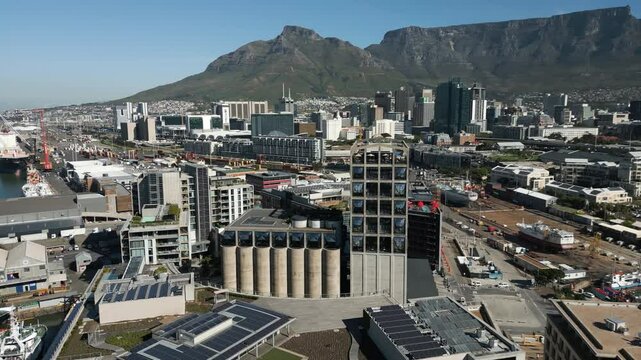 Aerial Drone Footage Captures The Stunning Zeitz Mocaa In Cape Town, South Africa. The Vibrant City And Mountains Surround The Museum On A Warm Summer Day, Showcasing The Bustling Port And Ships.