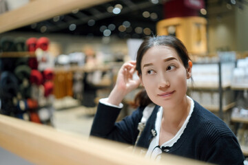 Thoughtful Young Woman in Modern Retail Space Setting