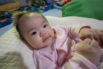 Close-up Portrait image of 3 month old baby girl of Asian Chinese child on happy mode