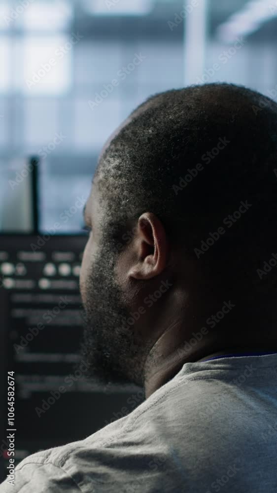 Poster system administrator working in computer network security data center listening music. african ameri
