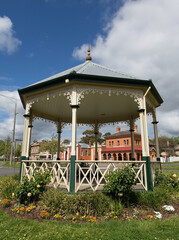 The Queen Victoria Bandstand in Creswick, Victoria, Australia was built in 1897 to honour Queen Victoria in her diamond jubilee year (with historic buildings in background.)  