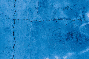 Grunge classic blue concrete background. Textured plaster wall. Creative backdrop for your design. Color of the year 2025 concept. Top view, layout for design. Surface with peeling shabby pattern.