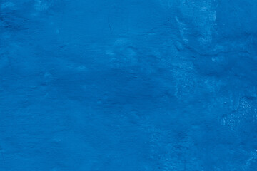 Grunge classic blue concrete background. Textured plaster wall. Creative backdrop for your design. Color of the year 2025 concept. Top view, layout for design. Surface with peeling shabby pattern.