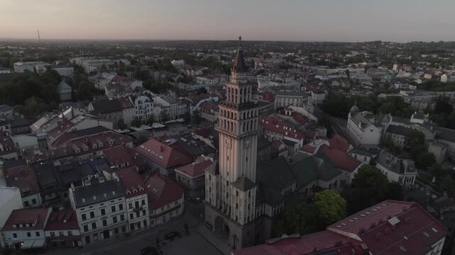 Clock tower above town at sunset 4k drone footage Dlog 10 Bit ungraded