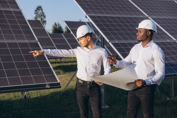 Engineers Discussing Solar Panel Project at Renewable Energy Site