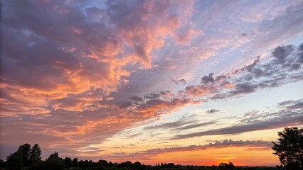 Gentle warmth emanates from a soft, watercolor sunset sky with hues of orange and purple blending seamlessly into each other, watercolor, abstract