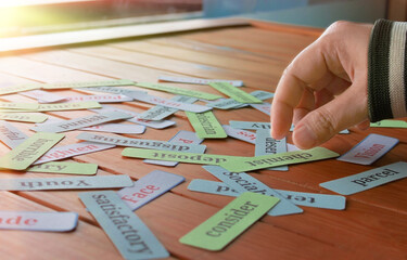 hand picking up cards in class