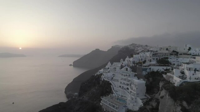 Pan left into sunset above cliff town 4k drone footage Dlog 10 Bit ungraded
