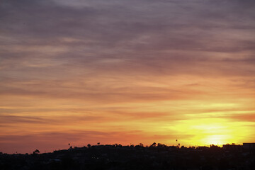 Panoramic sunrise or sunset dusk dawn landscape nature coastal scenery with beautiful fire sky and dramatic cloudscapes over California coast range view near Los Angeles