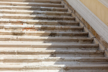 The stairs are dirty and have a shadow on them