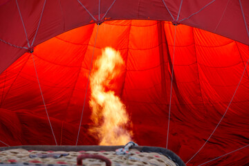 A hot air balloon with a fire in the bottom of it