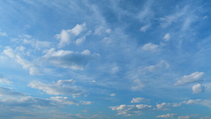 Obraz premium Background of clouds and sky on a sunny day. Light blue and white colours of real skies with clouds. Time lapse.