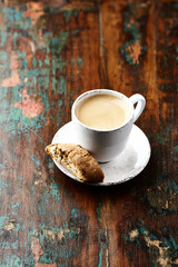 Cup of coffee and Cantuccini (Italian cookie) on dark wooden background. Copy space.