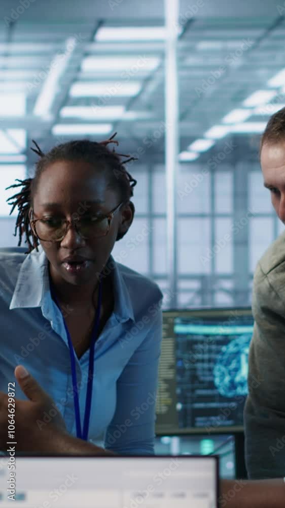 Poster multiethnic team of engineers working in server hub, using pcs to analyze data. multiracial group of
