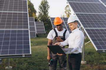 Engineers Discussing Solar Panel Installation at a Renewable Energy Site