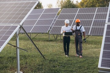 Engineers Discussing Solar Panel Installation in Field