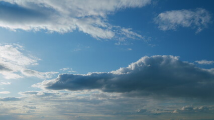 Obraz premium White clouds float across the blue sky. Puffy fluffy soft clouds. Timelapse.