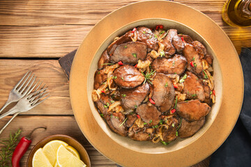 Arabic Cuisine; Tender lemon garlic chicken livers sauteed in  butter and coated in a sweet tangy pomegranate glaze. Garnished with rosemary and parsley.