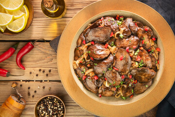 Arabic Cuisine; Tender lemon garlic chicken livers sauteed in  butter and coated in a sweet tangy pomegranate glaze. Garnished with rosemary and parsley.