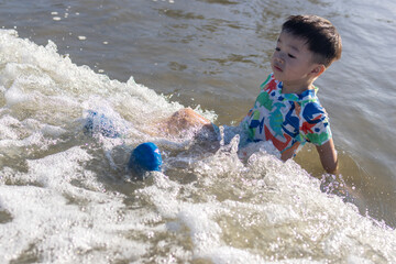 A joyful child plays in the sand at a sunlit beach, embodying the carefree spirit of summer and the joy of outdoor activities