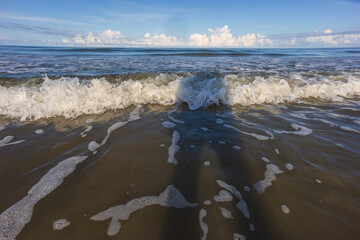 Point of view image of beautiful and clean beach with beach wave during evening