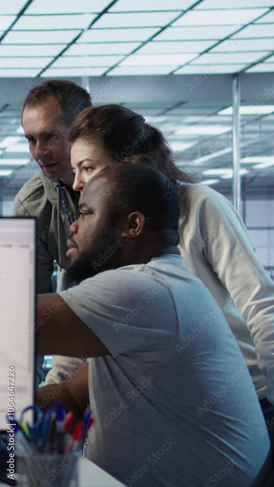 Poster multiethnic team of engineers working in server hub, using pcs to analyze data. multiracial group of