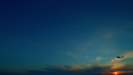 Sun halo is visible as cirrus clouds form in the sky. Gradient color. Time lapse.