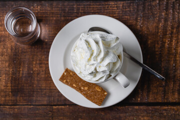 Mocha or white mocha coffee in white porcelain cup on wooden table