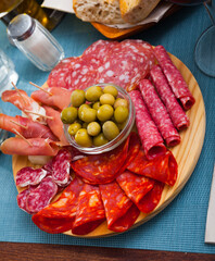 Cold smoked meat plate with traditional Spanish chorizo, fuet and salami sausages, sliced bacon and jamon