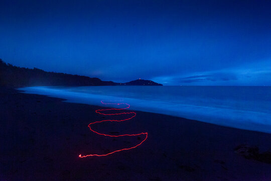 Red light trail on a beach in the Strait of Juan de Fuca.