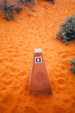 The Valley of Fire, a trail marker with an arrow on a sandy path.