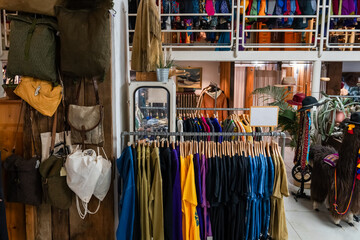 A lot of vintage and fashionable clothes in a second-hand store for recycling or resale to preserve...