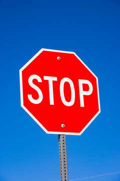 Stop sign against clear blue sky, USA.