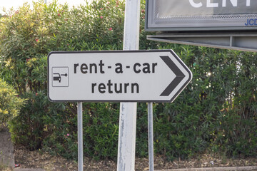 Obraz premium Rent a car return sign pointing to the right in an airport parking lot
