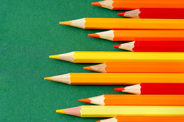 Sharpened pencils on a green background