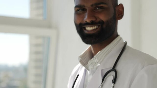Indian Man, dentist and happiness for oral care on portrait for teeth hygiene demonstration, treatment and whitening. Doctor, surgeon and closeup in healthcare with smile at clinic for canal procedure