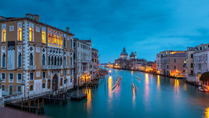 Venice, Italy - February 4, 2024: Grand Canal with Basilica di Santa Maria della Salute at sunset. Architecture and landmarks of Venice, Italy