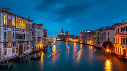 Venice, Italy - February 4, 2024: Grand Canal with Basilica di Santa Maria della Salute at sunset. Architecture and landmarks of Venice, Italy