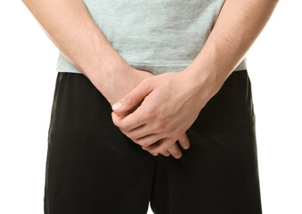 STD (sexually transmitted diseases). Man suffering from symptoms on white background, closeup