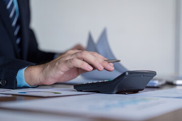 Finance Auditor Calculating Figures for Report Validation