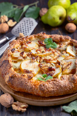 Homemade open pie (galette) with pears, blue cheese and walnuts.