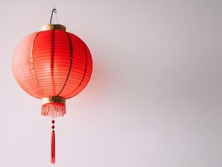 Obraz premium A Red Chinese Lantern Hanging Against a White Wall